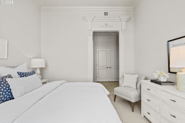 bedroom with crown molding, visible vents, and a closet