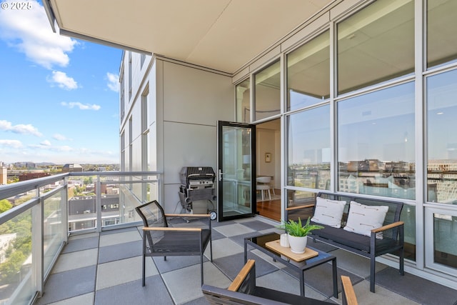 balcony with a view of city, an outdoor living space, and area for grilling