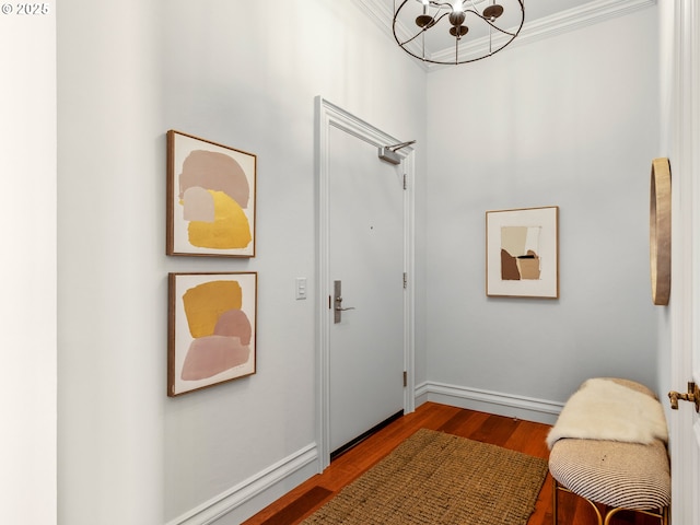 interior space featuring baseboards, wood finished floors, and a chandelier