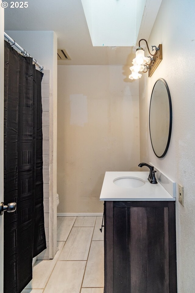 bathroom with vanity and tile patterned flooring