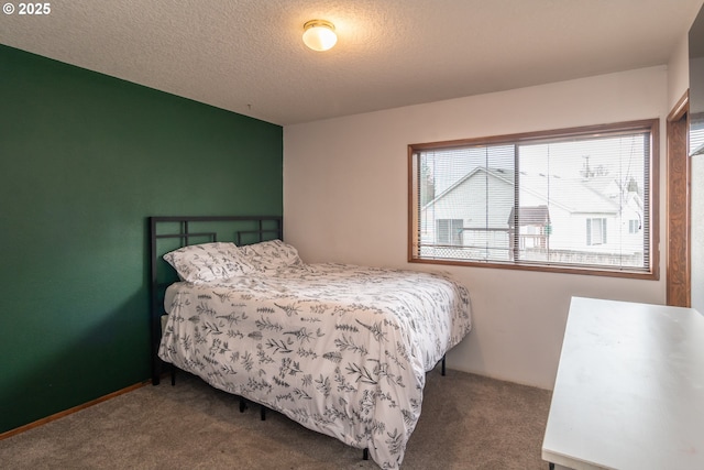 bedroom with carpet flooring and a textured ceiling