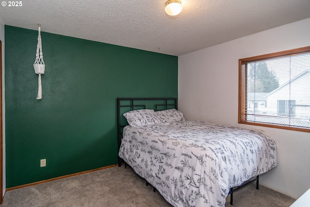 bedroom featuring carpet floors and a textured ceiling