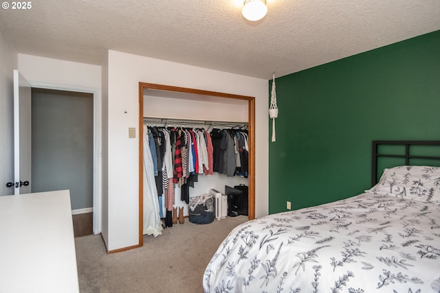 carpeted bedroom with a closet and a textured ceiling