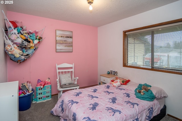 bedroom with carpet and a textured ceiling