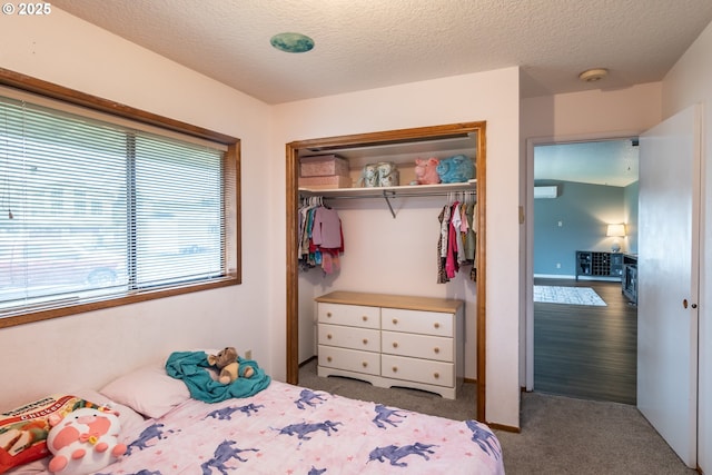 bedroom featuring light carpet, a closet, and a textured ceiling