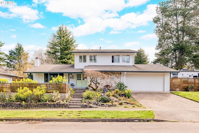 3730 NW 183rd Ave, Portland, OR 97229 - split level home featuring driveway, a chimney, covered porch, stairway, and stone siding