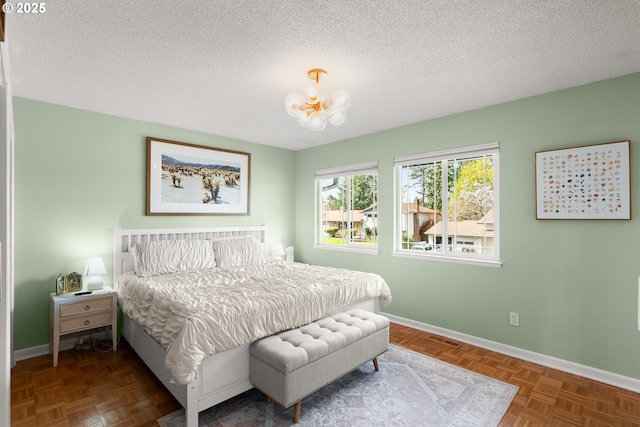 3730 NW 183rd Ave, Portland, OR 97229 - bedroom featuring a chandelier and a textured ceiling