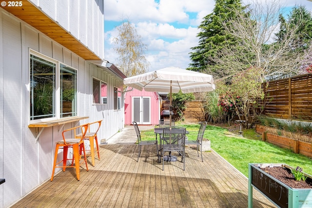 3730 NW 183rd Ave, Portland, OR 97229 - wooden terrace featuring outdoor dining area, a storage shed, and a fenced backyard