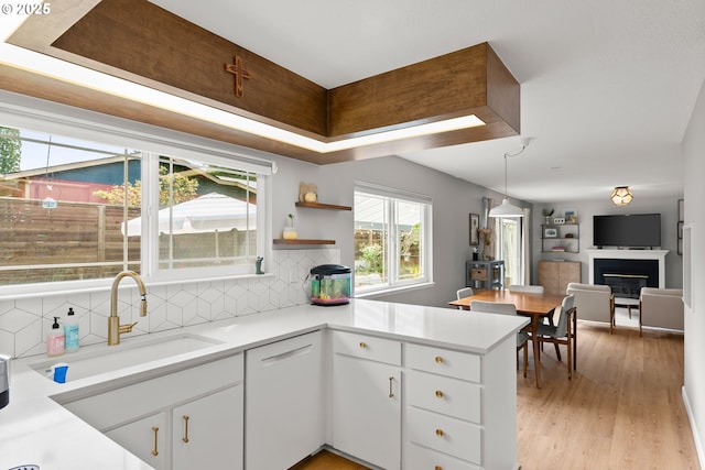 3730 NW 183rd Ave, Portland, OR 97229 - kitchen with a peninsula, decorative backsplash, light countertops, and white cabinetry