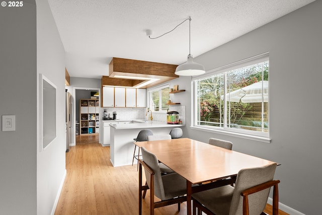 3730 NW 183rd Ave, Portland, OR 97229 - dining area with light wood-style floors and baseboards