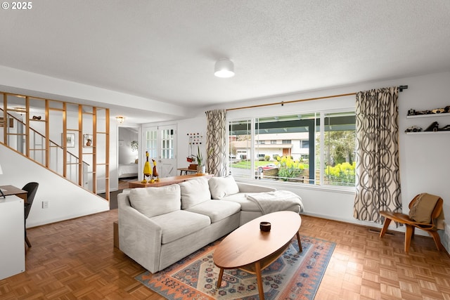 3730 NW 183rd Ave, Portland, OR 97229 - living room featuring stairs and a textured ceiling