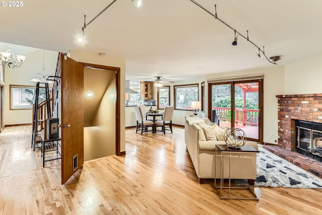 4939 Hampton Ct, Lake Oswego, OR 97035 - living room with track lighting, light wood-style flooring, a fireplace, and baseboards