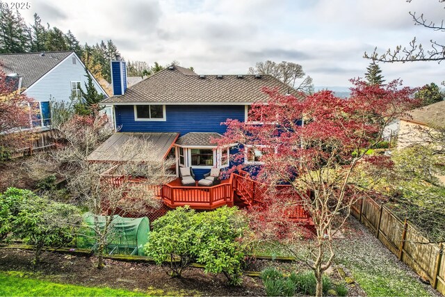 4939 Hampton Ct, Lake Oswego, OR 97035 - rear view of property featuring a fenced backyard, a chimney, a wooden deck, and roof with shingles