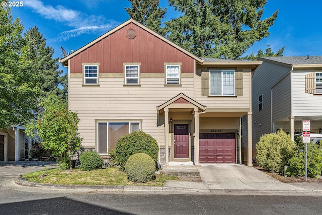 18246 SW Orlov Ct, Beaverton, OR 97078 - view of front of property with board and batten siding, an attached garage, and concrete driveway