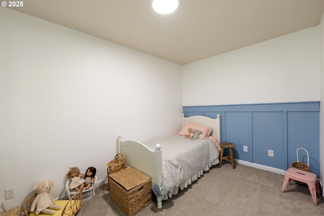 18246 SW Orlov Ct, Beaverton, OR 97078 - bedroom featuring a decorative wall, light colored carpet, and a wainscoted wall