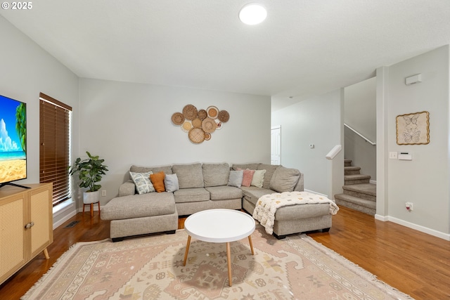 18246 SW Orlov Ct, Beaverton, OR 97078 - living room with wood finished floors, stairway, and baseboards