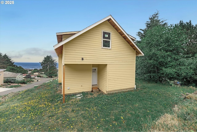 227 Windsong St, Yachats, OR 97498 - view of side of home with a lawn and a water view