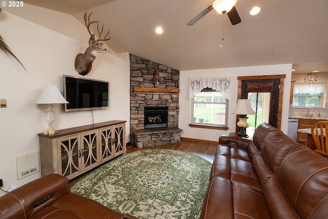 145343 Birchwood Dr, La Pine, OR 97739 - living area featuring ceiling fan, wood finished floors, vaulted ceiling, a stone fireplace, and recessed lighting