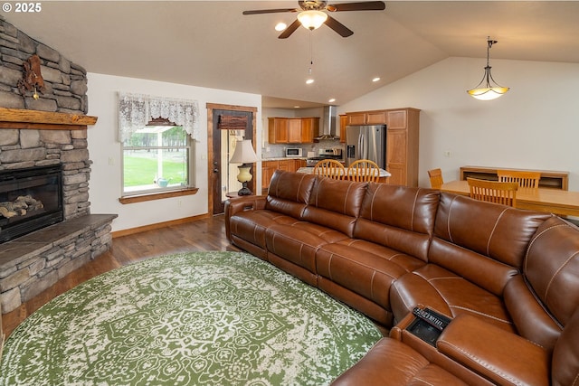 145343 Birchwood Dr, La Pine, OR 97739 - living area featuring a ceiling fan, a fireplace, vaulted ceiling, wood finished floors, and baseboards