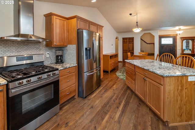 145343 Birchwood Dr, La Pine, OR 97739 - kitchen featuring appliances with stainless steel finishes, wall chimney exhaust hood, vaulted ceiling, dark wood finished floors, and decorative backsplash
