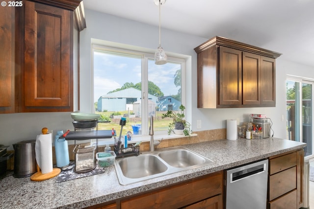 5615 Macleay Rd, Salem, OR 97317 - kitchen with stainless steel dishwasher, a sink, hanging light fixtures, and light countertops