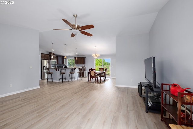 5615 Macleay Rd, Salem, OR 97317 - living area with light wood-type flooring, lofted ceiling, a ceiling fan, baseboards, and a chandelier