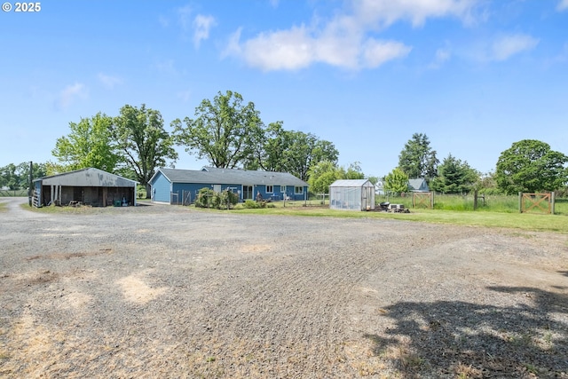 5615 Macleay Rd, Salem, OR 97317 - view of front of house with a greenhouse, an outdoor structure, and fence