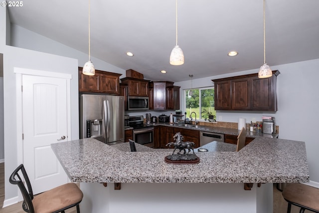 5615 Macleay Rd, Salem, OR 97317 - kitchen with appliances with stainless steel finishes, a sink, a breakfast bar, vaulted ceiling, and dark brown cabinets