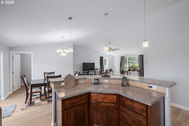 5615 Macleay Rd, Salem, OR 97317 - kitchen with lofted ceiling, light wood finished floors, hanging light fixtures, baseboards, and ceiling fan