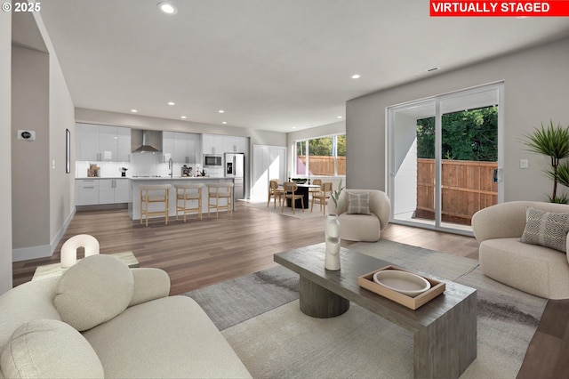 living room featuring light wood-type flooring and sink