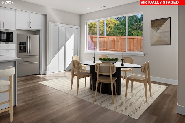 dining area featuring dark wood-type flooring