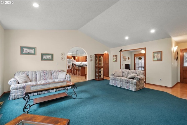 110 Dolph Dr, Ariel, WA 98603 - carpeted living room featuring lofted ceiling, arched walkways, and recessed lighting