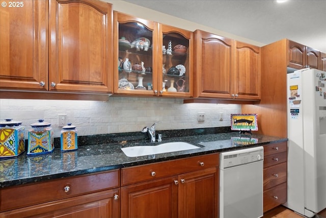 110 Dolph Dr, Ariel, WA 98603 - kitchen featuring white appliances, dark stone countertops, glass insert cabinets, and brown cabinets