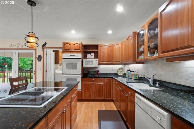 110 Dolph Dr, Ariel, WA 98603 - kitchen featuring white appliances, light wood finished floors, open shelves, brown cabinetry, and pendant lighting