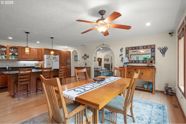 110 Dolph Dr, Ariel, WA 98603 - dining room with arched walkways, light wood-style flooring, ceiling fan, recessed lighting, and a textured ceiling