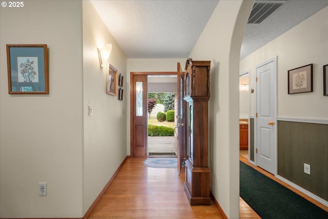 110 Dolph Dr, Ariel, WA 98603 - hall with light wood-type flooring, a textured ceiling, and arched walkways