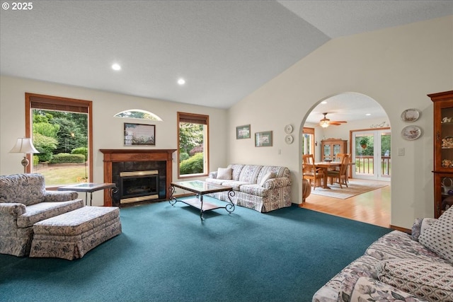110 Dolph Dr, Ariel, WA 98603 - living room featuring vaulted ceiling, arched walkways, a premium fireplace, healthy amount of natural light, and ceiling fan