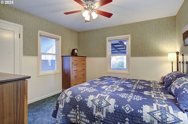 bedroom featuring multiple windows, carpet, and ceiling fan