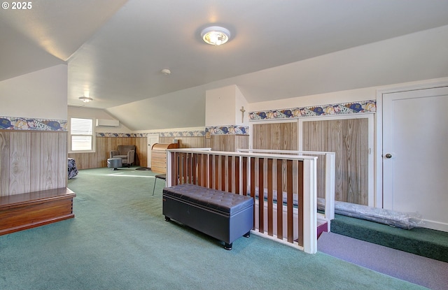 bedroom with carpet floors, a wall unit AC, and vaulted ceiling