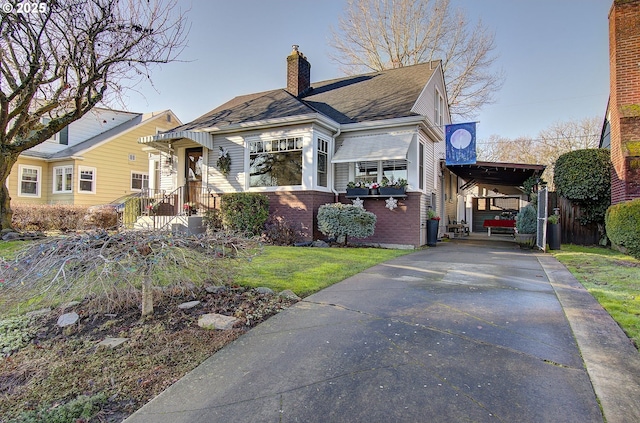 view of front of house with a front lawn and a carport