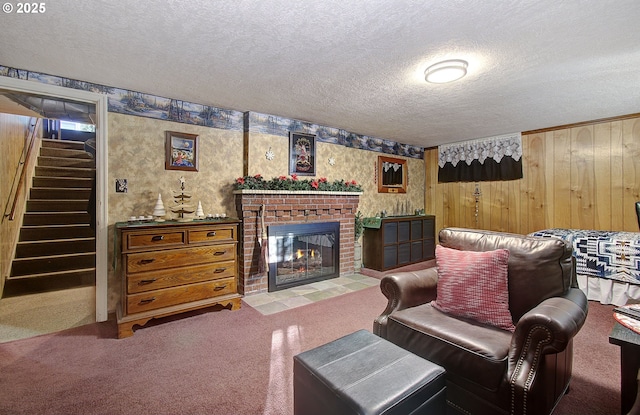 carpeted living room featuring a textured ceiling, wooden walls, and a brick fireplace