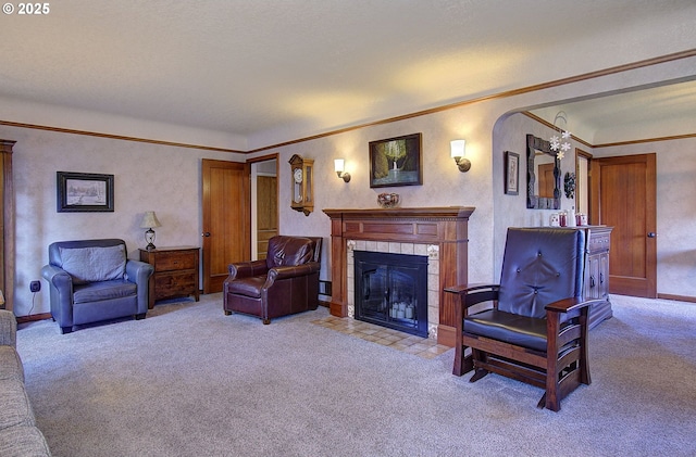 carpeted living room with a tiled fireplace