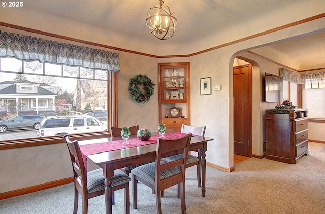 carpeted dining room featuring an inviting chandelier