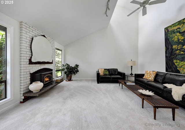 12420 Orchard Hill Rd, Lake Oswego, OR 97035 - carpeted living area featuring ceiling fan, a brick fireplace, track lighting, high vaulted ceiling, and baseboards