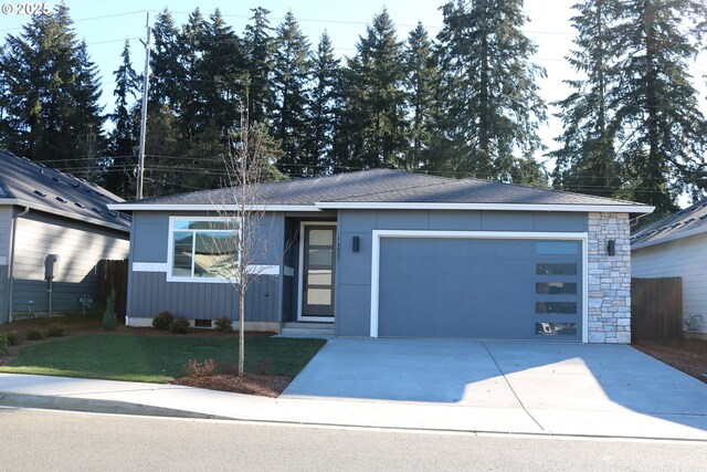 view of front of home featuring a garage and a front lawn