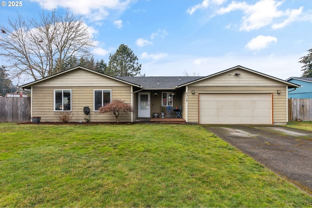 ranch-style home with a garage and a front yard