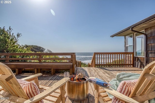deck with a beach view and a water view