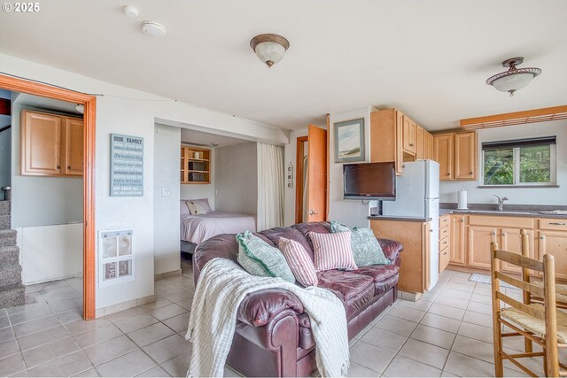 living area featuring heating unit, stairs, and light tile patterned flooring