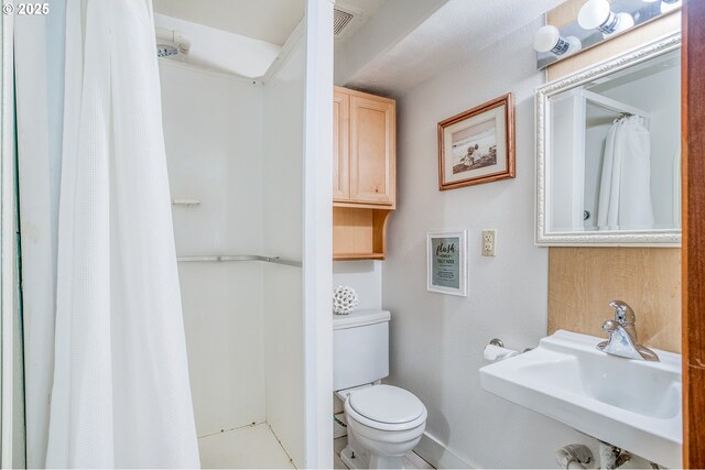 full bathroom featuring a sink, a shower with curtain, baseboards, and toilet