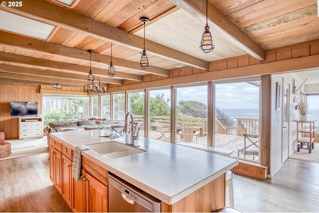 kitchen with stainless steel dishwasher, a sink, wooden ceiling, light wood finished floors, and open floor plan